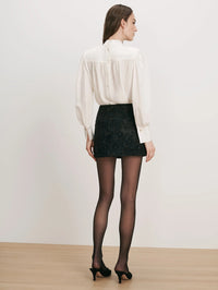 Back view of the Veronica Beard Brooks Mock-Neck Blouse in Dove White showing the fully buttoned back.