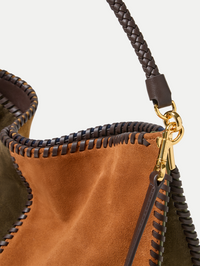 Close-up of braided leather handle and whipstitched edges on the Colorblock Vida Bag in Cypress Multi by Veronica Beard