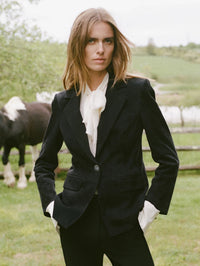 Campaign shot of the Veronica Beard Darlis Scarf-Neck Blouse in Dove White under a black velvet blazer.