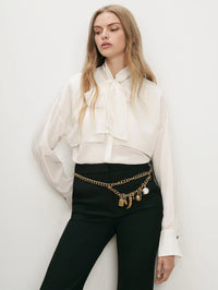 Front view of the Veronica Beard Darlis Scarf-Neck Blouse in Dove White tied at the neck.