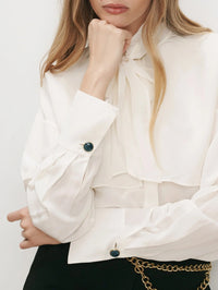 Detail of the scarf neck and cuffs on the Veronica Beard Darlis Scarf-Neck Blouse in Dove White.