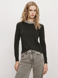 Front view of the Veronica Beard Daro Embellished Sweater in Green Shadow with crystal crew neckline, worn with grey jeans.