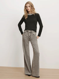 Full-length front view of the Veronica Beard Daro Embellished Sweater in Green Shadow styled with wide-leg jeans.