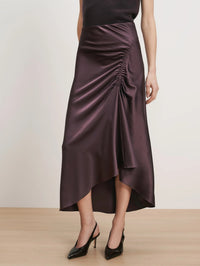 Close front view of the side waist ruching on the Veronica Beard Felecia Midi Skirt in Dark Eggplant.