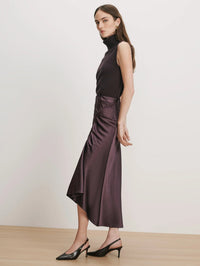 Side view of the draped hem on the Veronica Beard Felecia Midi Skirt in Dark Eggplant satin.