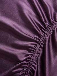 Detail of the gathered satin ruching on the Veronica Beard Felecia Midi Skirt in Dark Eggplant.