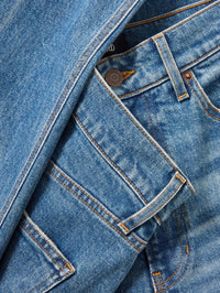 Close-up of the copper button and pocket stitching on the Veronica Beard Harley Arc-Leg Jean in Memory Lane