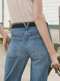Back pocket close-up of the Veronica Beard Harley Arc-Leg Jean in Memory Lane worn with a belt