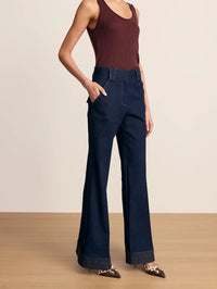 Three-quarter view of the Veronica Beard Lancelor Pant in Midnight Wash showing angled pocket and stitched hem.