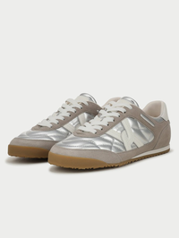 Three-quarter view of the Natalia Sneaker in silver and grey by Veronica Beard with quilted metallic leather