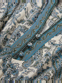 Close-up of ornate blue and navy print stripes on the Sama Dress in Ecru Multi by Veronica Beard