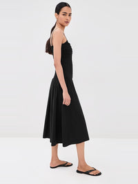 Side view of the Serenel Dress in black by Veronica Beard with pleated A-line skirt