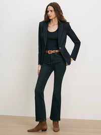 Styled view of the Veronica Beard Miller Denim Dickey Jacket in Midnight Wash with flare jeans and suede boots