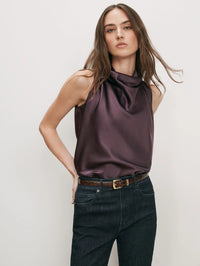 Front view of the Veronica Beard Tam Top in Dark Eggplant with a draped cowl neckline, tucked into dark jeans