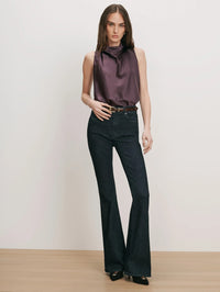 Full length front view of the Veronica Beard Tam Top in Dark Eggplant worn with dark flared jeans