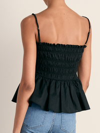 Back view of the Tullia Top in black by Veronica Beard, featuring smocked ruching and peplum hem