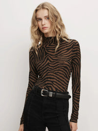 Front view of the Veronica Beard Wyeth Zebra Turtleneck Top in Ochre/Black, styled with a black belt and jeans.