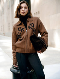 Street-style view of the White & Warren Cashmere Blend Horse Bomber in Umber/Black over a black turtleneck.