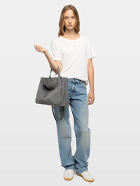 Full-length model shot of the Zadig & Voltaire Jack Suede Bag in Road grey worn on the shoulder.